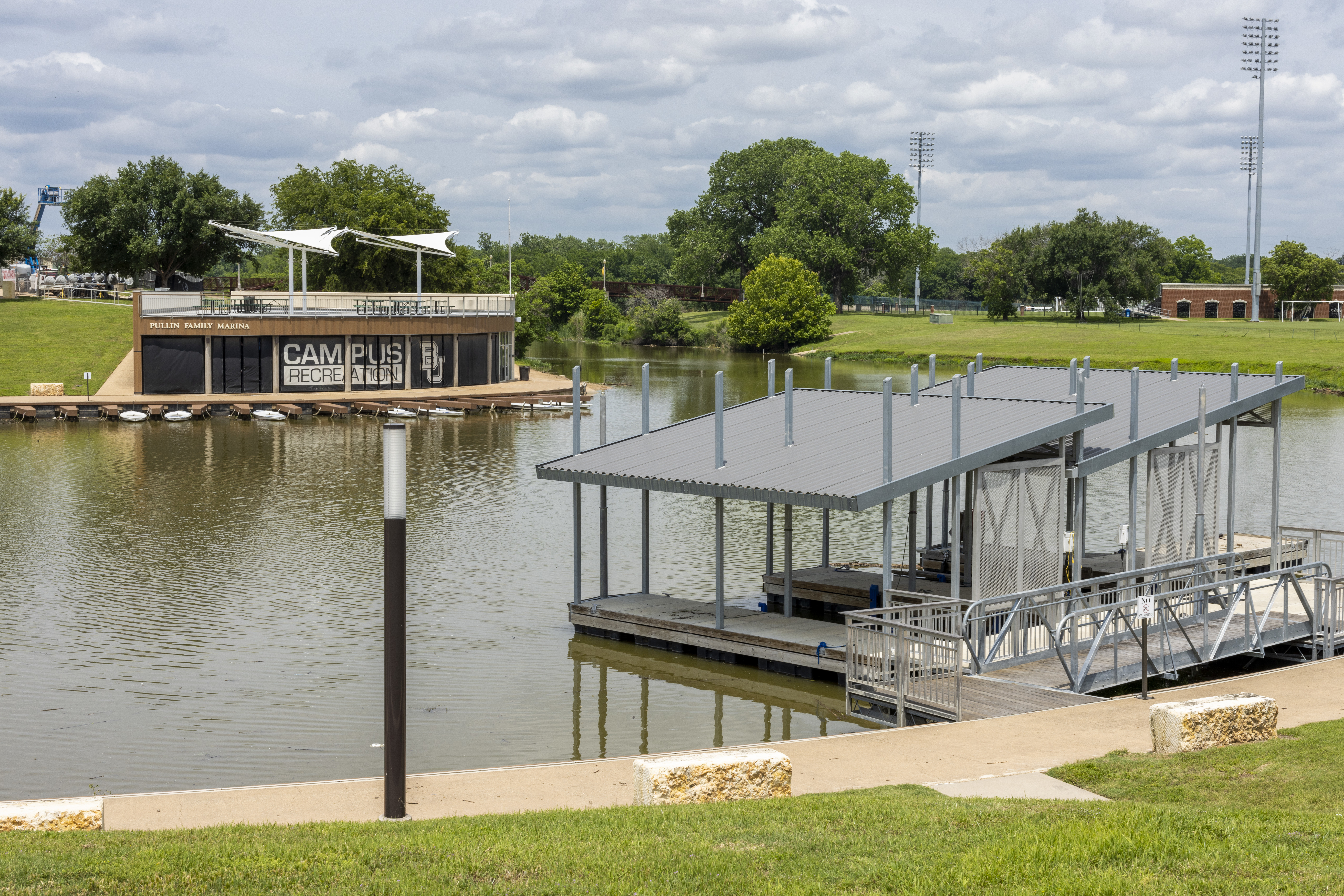 A landscape picture of the Baylor marina and the Brazos river. 
