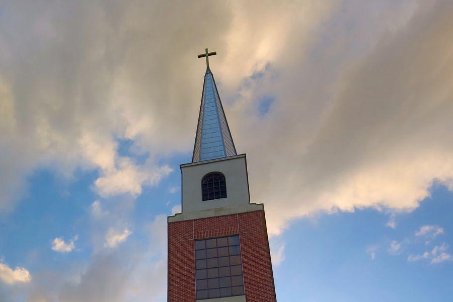 Photo of the Steeple Cross set against a cloudy blue sky