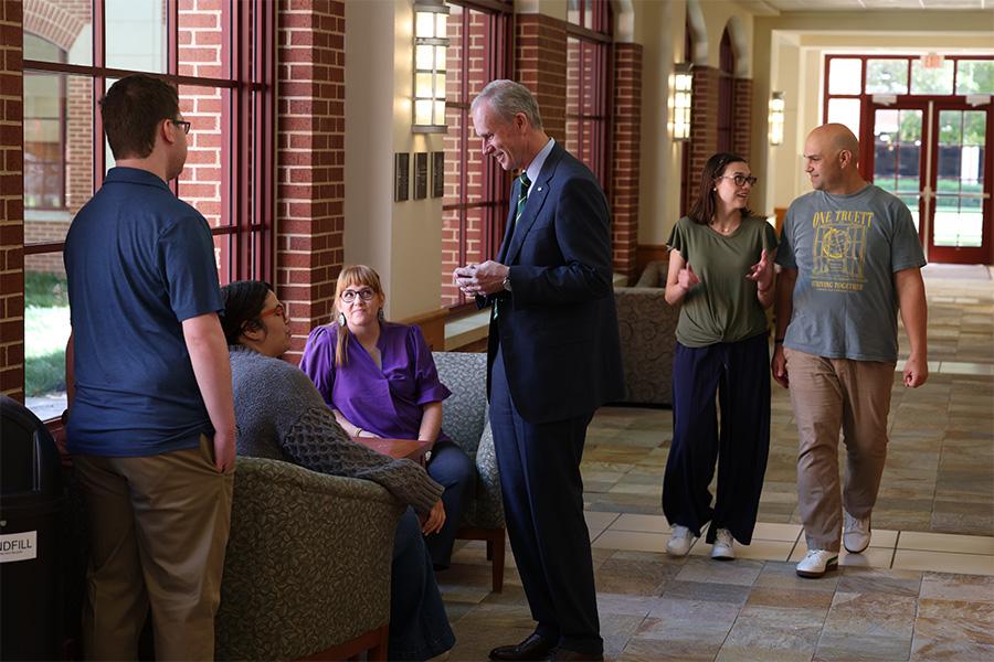 Dr. Still speaks with students in Truett's hallways